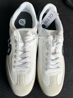 GUESS White Sneakers with Green Circle G Logo Accents.